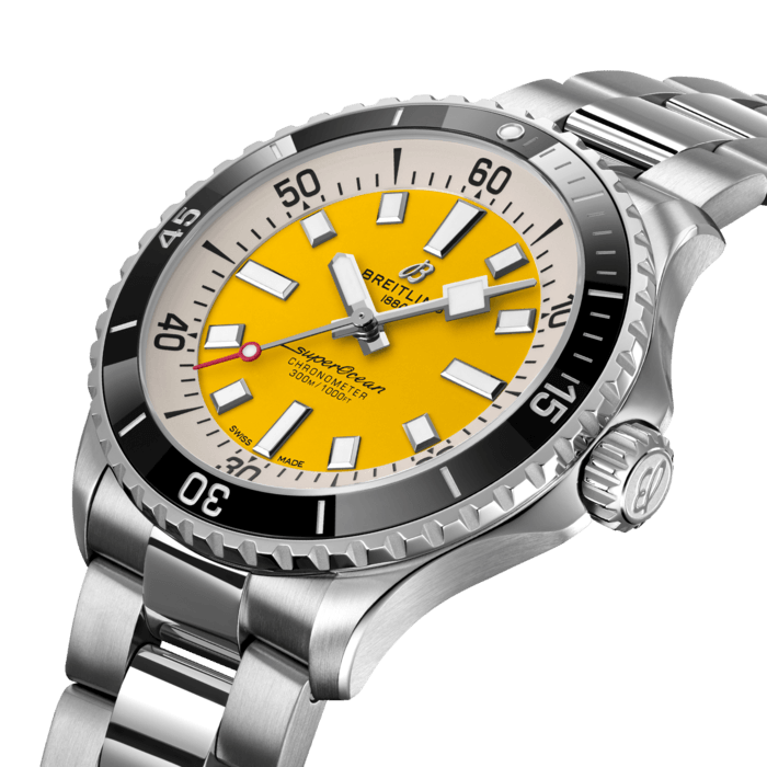 Performance and style for all your water-based pursuits—now in a special online exclusive with yellow dial.
In the 1960s, the new sport of scuba diving was all the rage. For divers, timing was everything, and Breitling set out to give them the most clear-cut dive watch possible by eliminating any feature that didn’t support their lifesaving needs underwater. This pared-down watch was named the Slow Motion. What remained were clean lines, chunky luminescent indexes, squared-off hands and a high-contrast dial ring, all aimed at maximum legibility. Practical, yes. But what people really fell in love with was the look.
The new Superocean retraces the Slow Motion's celebrated design codes, while adding modern features, like a ceramic-inlayed bezel and brightly colored dials. Broad hands and indexes in luminescent Super-LumiNova® allow for easy readability underwater. This special Breitling online exclusive features an eye-catching yellow dial. It’s water resistant to 300 m (1000 ft), as well as being shock-, sand- and saltwater-resistant. The two strap options (rubber and metal bracelet) have a folding clasp that allows for micro-adjustments of up to 15 mm for easy wear over rashies and wetsuits. Its scratch-proof ceramic inlayed bezel will never wear or fade. For safety, the bezel is uni-directional on most sizes and bi-directional with a patented lock on the 46 mm.
Best of all, this is no longer strictly a dive watch—surf with it, swim with it, hit the beach bar with it, then wear it out to dinner. The Superocean perfectly balances the nostalgia of its heritage with a fresh new look.