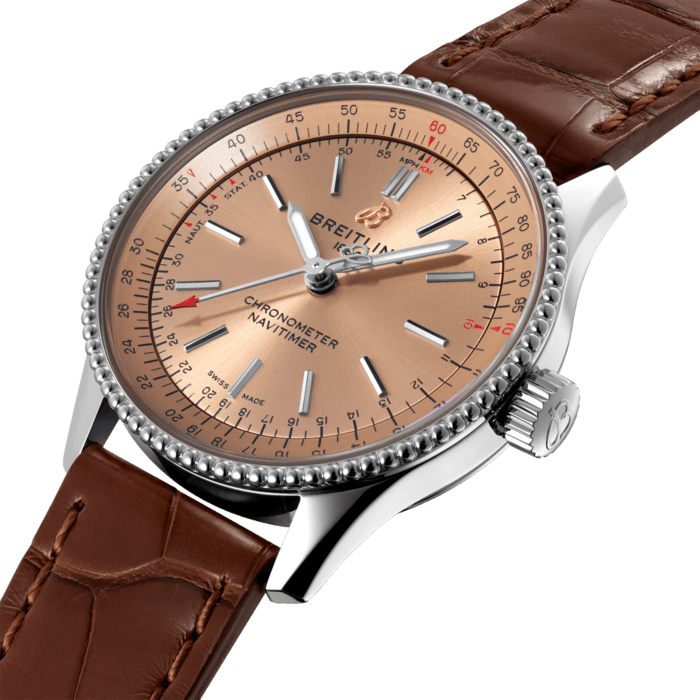 Refined and elegant, the Navitimer Automatic 35 combines the historic appeal of a true icon with the sophistication of a contemporary timepiece.
Available in a variety of materials including stainless steel and 18k red gold, the 35 mm case features a beaded bezel and a range of elegant dial colors, as well as diamond-set white mother of pearl. Offered either with a matching bracelet or alligator strap that fits both a stainless steel pin or folding buckle, the Navitimer Automatic 35 is powered by the Breitling Caliber 17, a COSC-certified chronometer.