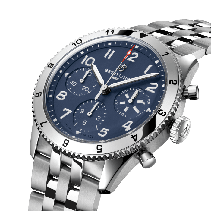 From brave first takeoffs to the birth of commercial air travel, Breitling’s history is inseparable from that of flight. In the 1930s, Breitling’s Huit Aviation department made its name inventing precision cockpit clocks. Two decades later, it introduced yet another novel flight instrument, this time in wearable form: the Ref. 765 AVI. That pioneering pilot’s watch provided the technical backdrop for today’s Classic AVI, a collection inspired by the rugged spirit of famed early aircraft.
The Classic AVI Tribute to Vought F4U Corsair honors one of those legends. As a WWII naval aircraft, the Vought F4U Corsair had to make tricky takeoffs and landings from carriers and remote landing strips. Speed and lift were of the essence, and the plane came through with flying colors, becoming the first single-engine fighter to crack the 400 mph (640 km/h) mark, while also providing an exceptional rate of climb. Its “bent-wing” design, oversized propeller and signature blue livery make it an emblem of aviation history.
As a true pilot’s watch designed to withstand the rigors of a vintage cockpit, the Classic AVI Tribute to Vought F4U Corsair features large, highly legible Arabic numerals on the dial and bezel.
The knurled bezel on the 42mm case provides optimal grip, even in a pilot’s gloved hands. Top-stitched calfskin straps give a nod to the seams found on classic flight gear, while the stainless-steel bracelet provides an elegant alternative. Pilots and other travelers will appreciate its legibility, wearability, and understated style. The engine of the Classic AVI is the COSC-certified Breitling Caliber 23 movement, which provides approximately 48-hours of power reserve.
