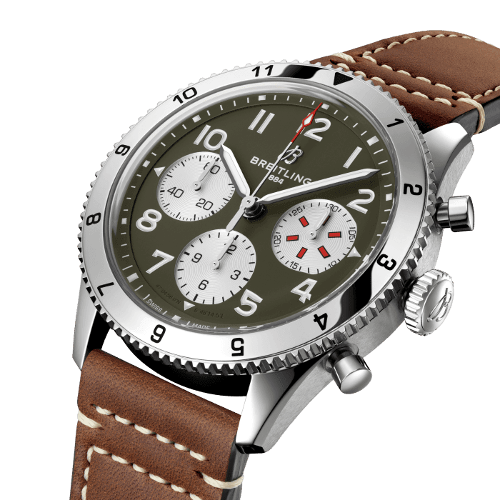 From brave first takeoffs to the birth of commercial air travel, Breitling’s history is inseparable from that of flight. In the 1930s, Breitling’s Huit Aviation department made its name inventing precision cockpit clocks. Two decades later, it introduced yet another novel flight instrument, this time in wearable form: the Ref. 765 AVI. That pioneering pilot’s watch provided the technical backdrop for today’s Classic AVI, a collection inspired by the rugged spirit of famed early aircraft.
The Classic AVI Curtiss P-40 Warhawk honors one of those legends. Conceived as a pursuit aircraft, the Curtiss P-40 Warhawk first flew in 1938 and quickly proved itself as a master of agility. It wasn’t just the plane’s capacity for pulling jaw-dropping turns that gave it an in-flight edge, its robust structure meant it could tolerate harsh weather conditions and even many mid-air collisions. The Warhawk’s defiant shark-mouth nose art sealed its reputation as the rebel of the skies.
As a true pilot’s watch designed to withstand the rigors of a vintage cockpit, the Classic AVI Curtiss P-40 Warhawk features large, highly legible Arabic numerals on the dial and bezel.
The knurled bezel on the 42mm case provides optimal grip, even in a pilot’s gloved hands. Top-stitched calfskin straps give a nod to the seams found on classic flight gear, while the stainless-steel bracelet provides an elegant alternative. Pilots and other travelers will appreciate its legibility, wearability, and understated style. The engine of the Classic AVI is the COSC-certified Breitling Caliber 23 movement, which provides approximately 48-hours of power reserve.