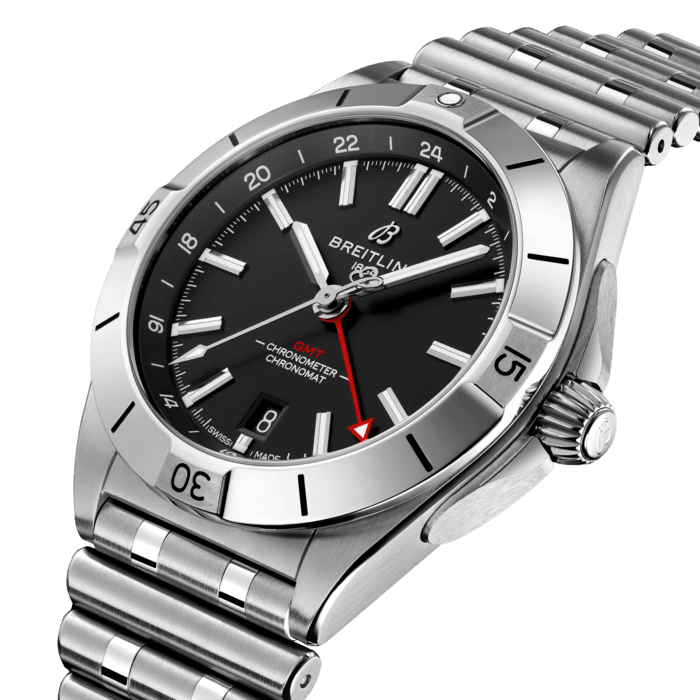 The Chronomat Automatic GMT 40 is Breitling’s tribute to travel, not only for its dual time zone display, but also because of its easygoing aesthetics. Subtle dial colors, combined with an all-steel case and bracelet, work with any wardrobe. Meanwhile, the tone-on-tone 24-hour scale lets the red GMT hand speak for itself.
The Breitling Caliber 32 powers the GMT complication. Its 24-hour scale lets the user track a second time zone and know at a glance whether it’s day or night, while the “onion” crown (a classic Chronomat feature named for its fluted-dome shape) allows for easy adjustments. As an all-purpose sports watch, meant to cross over between Breitling’s air, land and sea universes, the GMT 40 has an impressive 200m water resistance.
Known as “a watch for every pursuit,” the Chronomat mission is truer now than ever because of the GMT 40’s practical size and understated style. Sturdy enough for the gym, yet smart enough for black tie: If there’s one watch to travel with, this is it.