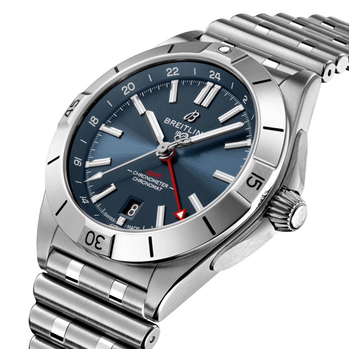 The Chronomat Automatic GMT 40 is Breitling’s tribute to travel, not only for its dual time zone display, but also because of its easygoing aesthetics. Subtle dial colors, combined with an all-steel case and bracelet, work with any wardrobe. Meanwhile, the tone-on-tone 24-hour scale lets the red GMT hand speak for itself.
The Breitling Caliber 32 powers the GMT complication. Its 24-hour scale lets the user track a second time zone and know at a glance whether it’s day or night, while the “onion” crown (a classic Chronomat feature named for its fluted-dome shape) allows for easy adjustments. As an all-purpose sports watch, meant to cross over between Breitling’s air, land and sea universes, the GMT 40 has an impressive 200m water resistance.
Known as “a watch for every pursuit,” the Chronomat mission is truer now than ever because of the GMT 40’s practical size and understated style. Sturdy enough for the gym, yet smart enough for black tie: If there’s one watch to travel with, this is it.