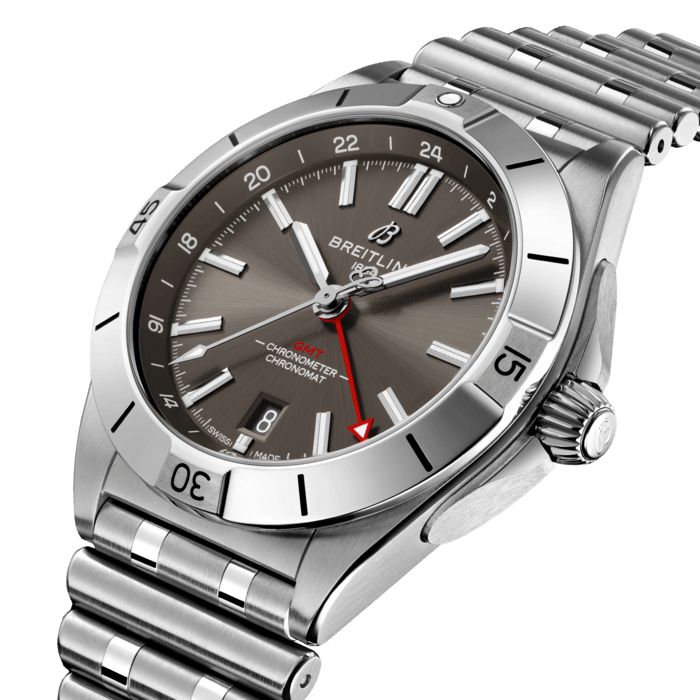 The Chronomat Automatic GMT 40 is Breitling’s tribute to travel, not only for its dual time zone display, but also because of its easygoing aesthetics. Subtle dial colors, combined with an all-steel case and bracelet, work with any wardrobe. Meanwhile, the tone-on-tone 24-hour scale lets the red GMT hand speak for itself.
The Breitling Caliber 32 powers the GMT complication. Its 24-hour scale lets the user track a second time zone and know at a glance whether it’s day or night, while the “onion” crown (a classic Chronomat feature named for its fluted-dome shape) allows for easy adjustments. As an all-purpose sports watch, meant to cross over between Breitling’s air, land and sea universes, the GMT 40 has an impressive 200m water resistance.
Known as “a watch for every pursuit,” the Chronomat mission is truer now than ever because of the GMT 40’s practical size and understated style. Sturdy enough for the gym, yet smart enough for black tie: If there’s one watch to travel with, this is it.