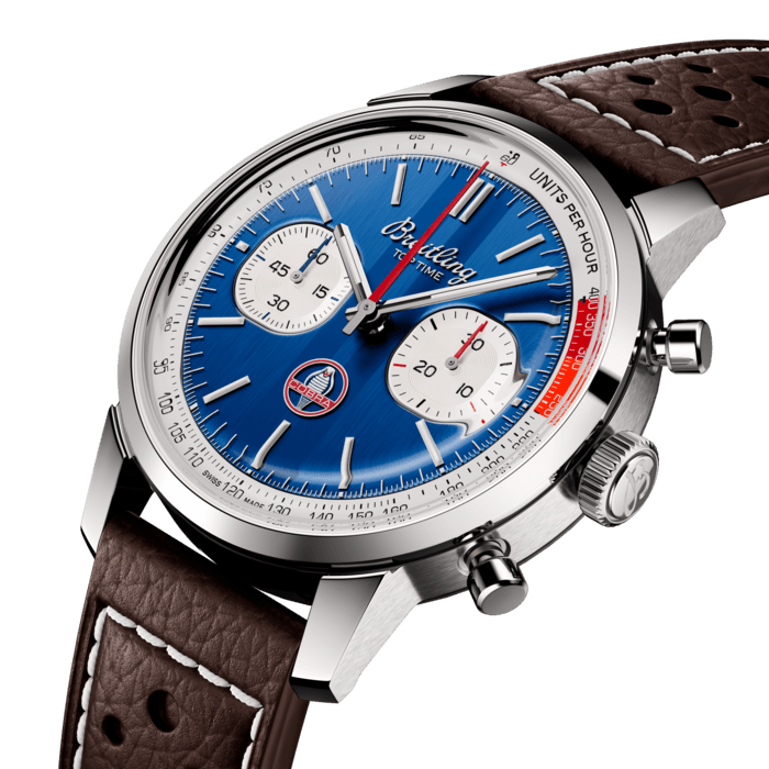 The 1960s was a decade of experimentation, fun, freedom and energy. Whether cruising on a motorcycle or revving up a sportscar, living life at full speed was the order of the day. Willy Breitling felt this change of pace and set out to design an unconventional chronograph that would capture the verve of era. He called it the Top Time.
That spirited tradition continues today with Breitling partnering with some of the coolest names in wheels to create its Top Time designs. In the early 1960s, the Le Mans winner Carroll Shelby imagined a car that matched a small, light British-style chassis to a strong, reliable American small-block engine. When it was introduced in 1962, the Cobra met with instant success, both among sportscar fans and on the racing circuit. It remains blisteringly fast and cherished by collectors to this day.
The Top Time B01 Shelby Cobra features the colors and emblem of its classic-car counterpart as well as a perforated leather racing strap, speed-measuring tachymeter scale and contrasting “squircle” (not quite square, not quite round) subdials that give the feel of vintage dashboard gauges. It also comes with a brag-worthy engine under the hood: the exceptional Breitling Manufacture Caliber 01.