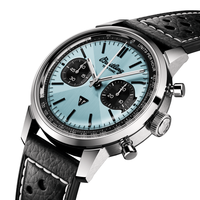 The 1960s was a decade of experimentation, fun, freedom and energy. Whether cruising on a motorcycle or revving up a sportscar, living life at full speed was the order of the day. Willy Breitling felt this change of pace and set out to design an unconventional chronograph that would capture the verve of era. He called it the Top Time.
That spirited tradition continues today with Breitling partnering with some of the coolest names in wheels to create its Top Time designs.
A collaboration with British heritage motorcycle brand Triumph, this watch’s highlight is its ice-blue dial. The distinctive shade was precisely color matched to a Triumph Thunderbird 6T from 1951, and a rare, blue-dialed Breitling Top Time Ref. 815 from the 1970s.
Collectors are sure to pick up on a few other throwbacks to vintage Breitling that include a retro logo, mushroom chronograph pushers and a “Zorro” dial design. The bowtie motif introduced on Top Time in the 1960s (and nicknamed for the wily swashbuckler’s mask) has been subtly integrated using a metal brushing technique that creates a radiant play of light and texture.
The design features a Triumph emblem at 6 o’clock, a speed-measuring tachymeter scale and contrasting “squircle” (not quite square, not quite round) subdials that give the feel of a vintage dashboard gauge. It also comes with a brag-worthy engine under the hood: the exceptional Breitling Manufacture Caliber 01.