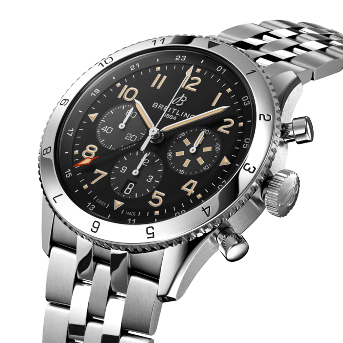 From brave first takeoffs to the birth of commercial air travel, Breitling’s history is inseparable from that of flight. In the 1930s, Breitling’s Huit Aviation department made its name inventing precision cockpit clocks. Two decades later, it introduced yet another novel flight instrument, this time in wearable form: the Ref. 765 AVI. That pioneering pilot’s watch provided the technical backdrop for today’s Super AVI, a collection inspired by the rugged spirit of famed early aircraft.
The Super AVI P-51 Mustang honors one of those legends. When the aircraft was built in a mere 120 days, even its developer North American Aviation, didn’t anticipate what a powerhouse it had on its hands. The P-51’s low-drag wings and engine-cooling system—considered experimental when the single-seat fighter first took off in 1940—gave it unprecedented speed and range. The addition of a Merlin engine, expanded the plane’s performance to high altitudes, making it the best all-purpose fighter of its time.
As a true pilot’s watch designed to withstand the rigors of a vintage cockpit, the Super AVI P-51 Mustang features large, highly legible Arabic numerals on the dial and bezel. The oversized crown and knurled bezel on its sturdy 46mm case provide optimal grip, even in a pilot’s gloved hands. Top-stitched calfskin straps give a nod to the seams found on classic flight gear, while the optional stainless-steel bracelet provides an elegant alternative. Pilots and other travelers will appreciate the ability to track a second time zone using the 24-hour marking on the inner bezel and the red-tipped GMT hand. The engine of the Super AVI is the COSC-certified Breitling Manufacture Caliber B04 movement, which provides approximately 70-hours of power reserve.