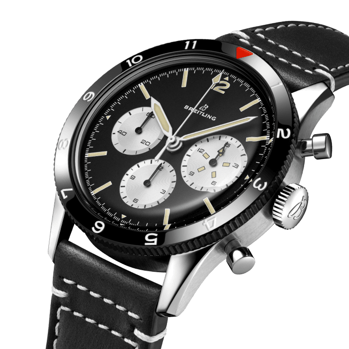 First released in 1953, the original Ref. 765 AVI, dubbed the “Co-Pilot,” was a workhorse timepiece designed to serve pilots in the often unforgiving conditions of a single-seat cockpit. Its size, legibility and ease of use made it a trusted flight instrument. By the 1960s, the AVI’s simplified style and oversized proportions made it a watch to wear well beyond aviation circles, and was to be seen on the wrist of celebrities and sports stars of the time.
The Ref. 765 AVI 1964 Re-Edition, released in a limited production of 164 pieces, faithfully reproduces the Ref. 765 AVI’s design. It includes a true-to-the-time hesalite crystal, as well as the baton indexes and lumed pencil hands used on the original. It also features modern improvements, like the durable amorphous diamond-like-carbon (ADLC) coated bezel that gives it its black finish. To maintain its vintage character, the watch is powered by the Caliber B09, a current Breitling manufacture movement that is, appropriately, manual wind. Its limitation references the watch’s original 1964 release with the caseback engraving “One of 164.”