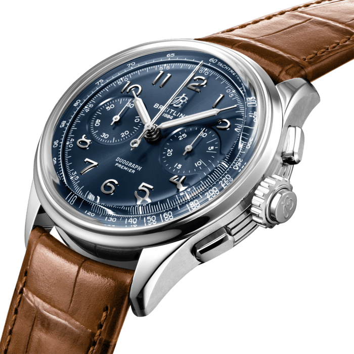 Paying homage to three generations of inventors – Léon, Gaston & Willy Breitling – the Premier Duograph displays Breitling’s watchmaking expertise with its split second complication. As Willy Breitling said, the Premier is an “unmistakable stamp of impeccable taste”.
This latest generation of Premier chronographs brings its timeless elegance back to life, and showcases Breitling’s highest level of watchmaking thanks to a range of iconic Premier complications: the Chronograph, the Duograph and the Datora.
Featuring rectangular chronograph pushers, bi-compax chronograph look and Arabic numerals, the heritage-revived Premier chronographs display a variety of elegant design details such as grooves on the case-sides, open sapphire casebacks and vintage-inspired hands.
The Duograph comes in two variations: in stainless steel with a blue dial and a gold brown alligator strap or in 18k red gold with a black dial and a black alligator strap.
“Duograph” was a term used by Breitling in the 1940s and refers to a “chronograph rattrapante". A rattrapante (from the French “rattraper” – to catch up) is one of the most elaborate of all watch complications. In terms of manufacturing difficulty, it’s on a par with the tourbillon and minute repeater. Its function is to measure two elapsed times at once (intermediate and split time), which it shows via two hands on the central chronograph. The Duograph is powered by the manually wound cosc-certified Breitling Manufacture Caliber B15, featuring two patented innovations: one to simplify the mechanism and the other to improve accuracy.